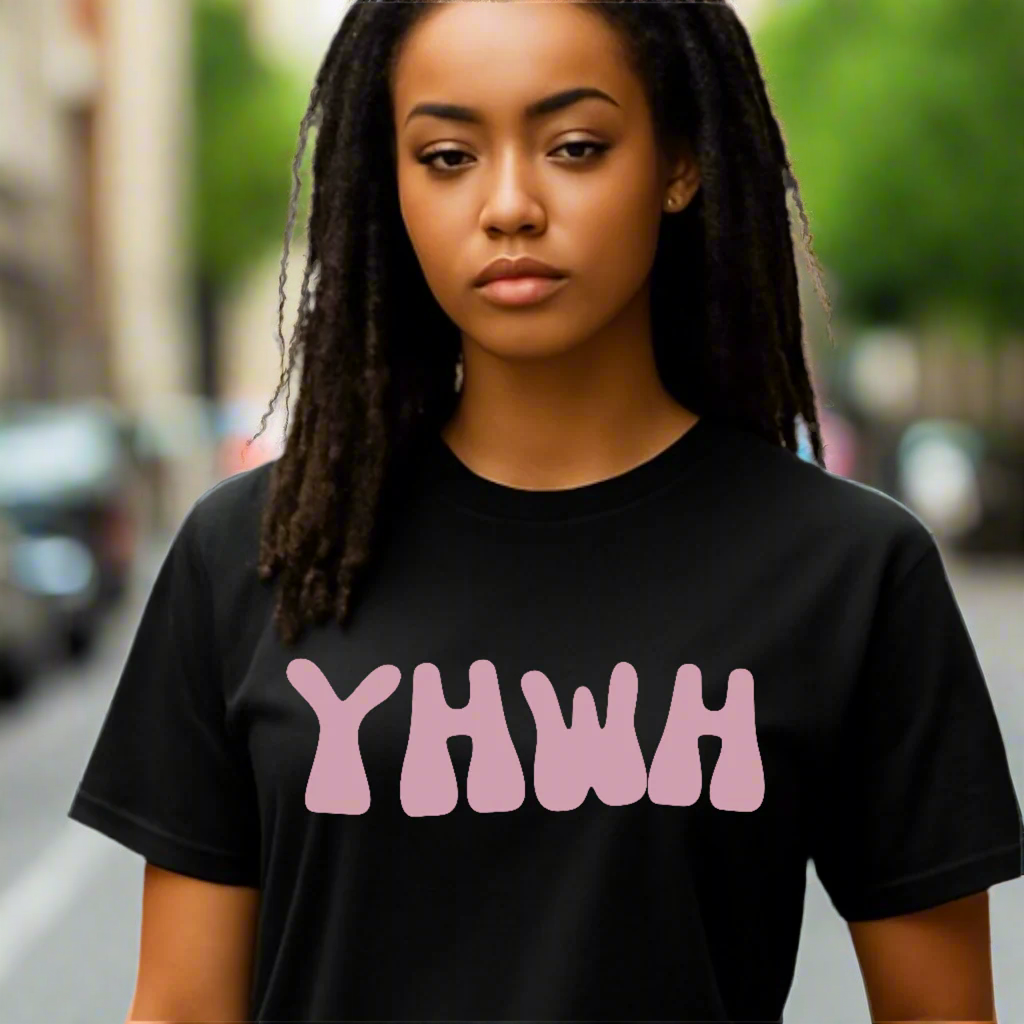 Person wearing a black t-shirt with pink text on a plain background